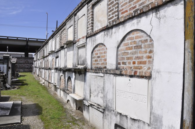 Headstones and caskets in the walls of the cemetary